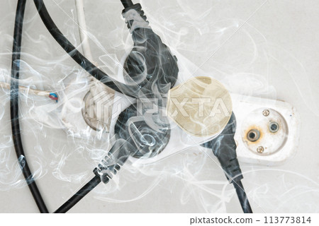 Failure caused by burning of the wire cable and socket outlet plug in the house, selective focus. 113773814