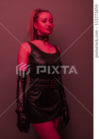 Beautiful young woman in a leather dress and... - Stock Photo [113773859] -  PIXTA