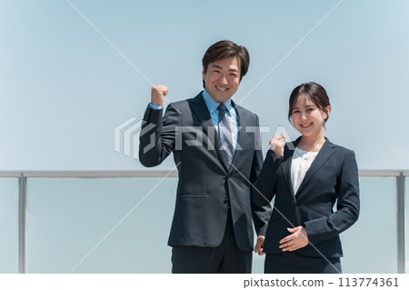 Men and women in suits doing fist pumps under the blue sky (motivation, hard work, rewarding) Men and women in suits doing fist pumps under the blue sky (motivation, hard work, rewarding) 113774361