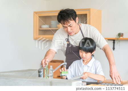 Son and boy helping father wash dishes 113774511