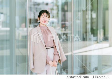 Young Asian businesswoman in urban office district 113774599