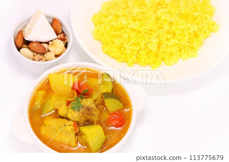 Nepalese soup curry with zucchini, potatoes, chicken and yellow rice on a light background Nepalese soup curry with zucchini, potatoes, chicken and yellow rice on a light background 113775679