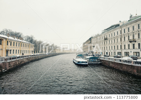 pleasure boat is moored on the river in a spring snowstorm 113775800