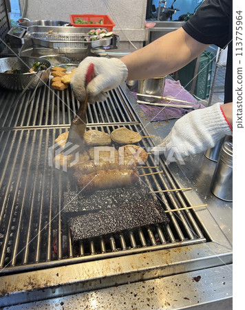 拍攝販賣燒烤的攤販正在為燒烤塗上烤肉醬 113775964
