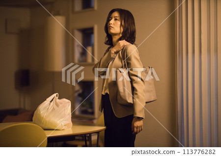 Night routine of a business woman who puts ingredients on the table after returning home Night routine of a business woman who puts ingredients on the table after returning home 113776282
