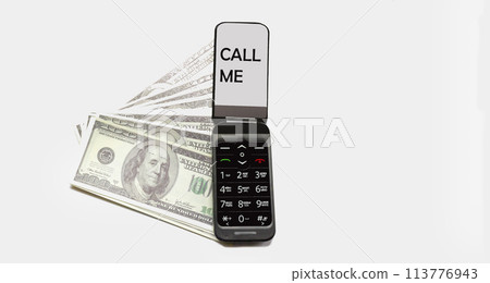 Mobile phone with text Call me. There are dollars nearby on a white background Mobile phone with text Call me. There are dollars nearby on a white background 113776943
