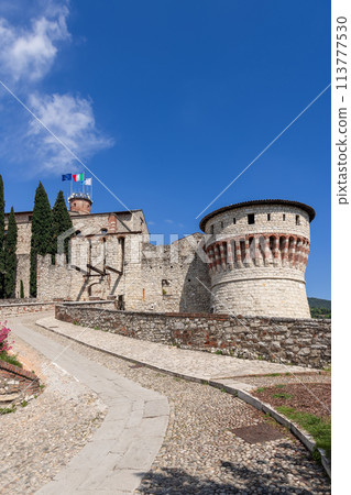 Stone drawbridge entrance to Brescia Castle with Mirabella Tower Stone drawbridge entrance to Brescia Castle with Mirabella Tower 113777530