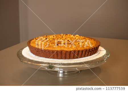 A rich chocolate tart with a luscious hazelnut cream topping A rich chocolate tart with a luscious hazelnut cream topping 113777539