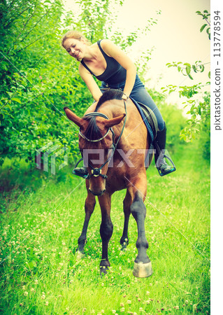 Young woman hugging and leaning out of house 113778594