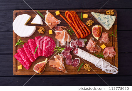 Board with meat, sausages and cheese . Top view Board with meat, sausages and cheese . Top view 113778620