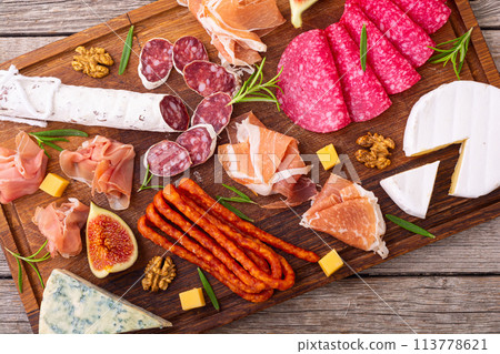 Board with meat, sausages and cheese . Top view Board with meat, sausages and cheese . Top view 113778621