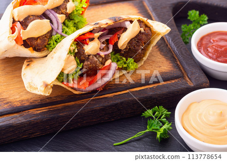 Pita with falafel, paprika and onion 113778654