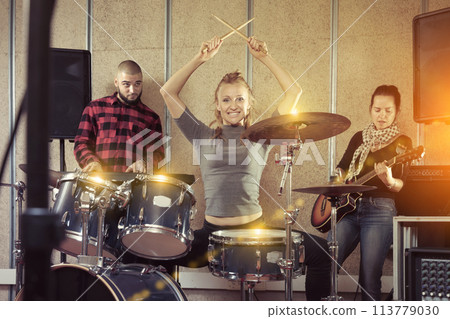Music band with glad girl drummer rehearsing Music band with glad girl drummer rehearsing 113779030