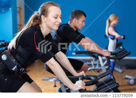 Athletic young people during functional workout with electric muscle stimulation in fitness gym 113779209