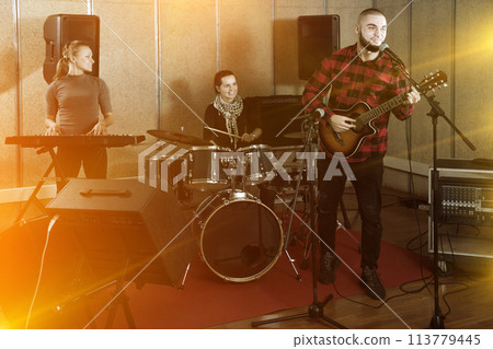 Emotional guy with guitar rehearsing Emotional guy with guitar rehearsing 113779445