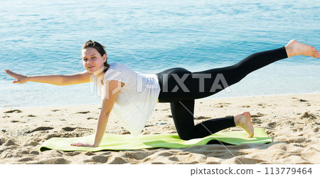 Woman in white T-shirt is stretching 113779464