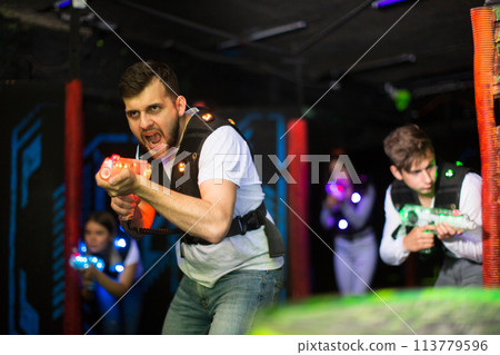 Excited guy during lasertag game Excited guy during lasertag game 113779596