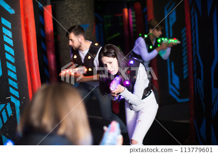 Girl during lasertag game Girl during lasertag game 113779601
