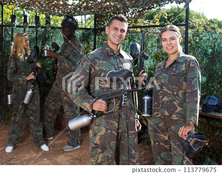 Confident man and woman paintball players Confident man and woman paintball players 113779675