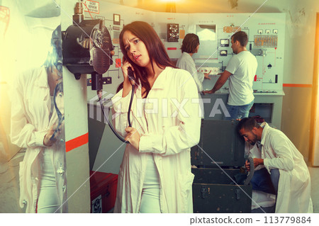 Girl using telephone set in escape room 113779884