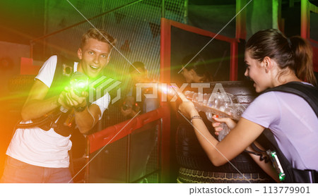 Positive guy holding laser guns and took aim during laser tag ga 113779901