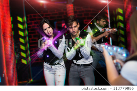 Couple playing laser tag Couple playing laser tag 113779996