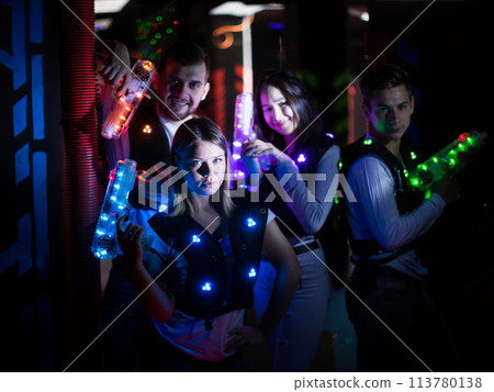 Young people in laser tag labyrinth Young people in laser tag labyrinth 113780138