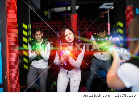 Girl playing laser tag in colorful beams 113780139