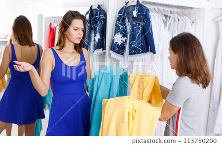 Girl expressing her indignation about quality of clothes 113780200