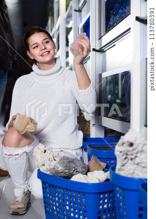 teenager selecting interesting aquarium rocks and stone for aquarium entourage teenager selecting interesting aquarium rocks and stone for aquarium entourage 113780391