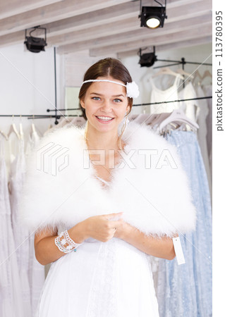 Woman flaunting dressed in wedding gown Woman flaunting dressed in wedding gown 113780395