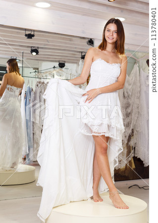 Girl fitting wedding dress 113780401