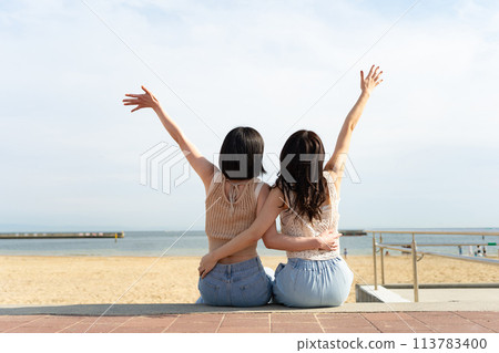 Two women playing on the beach 113783400