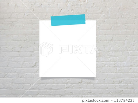 Light blue masking tape and blank note paper attached to a gray brick wall 113784225