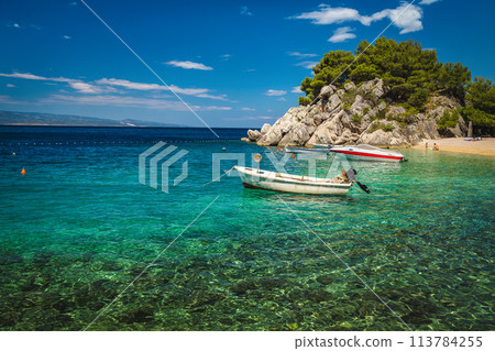 Beautiful beach and moored boats on the Adriatic Sea, Croatia 113784255