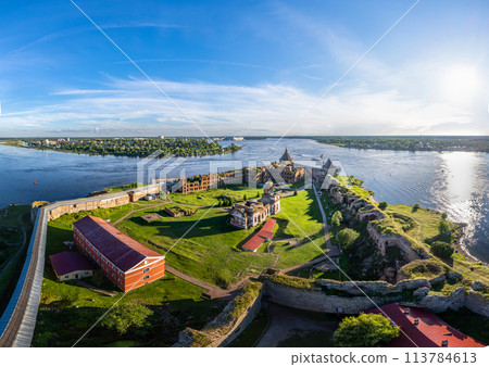 Europe. Russia, Leningrad region, St. Petersburg, Aerial panoramic view on fortress Oreshek near Schlesselburg town. Ancient Russian fort on island in Ladoga lake in sunny summery day Europe. Russia, Leningrad region, St. Petersburg, Aerial panoramic view on fortress Oreshek near Schlesselburg town. Ancient Russian fort on island in Ladoga lake in sunny summery day 113784613
