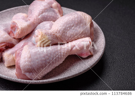 Fresh raw chicken legs with salt and spices Fresh raw chicken legs with salt and spices 113784686