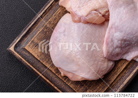 Fresh raw chicken thighs with salt and spices Fresh raw chicken thighs with salt and spices 113784722