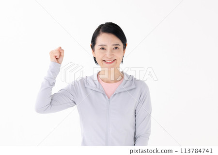 Woman in sportswear, fist pump Woman in sportswear, fist pump 113784741