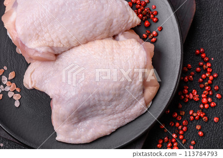 Fresh raw chicken thighs with salt and spices 113784793