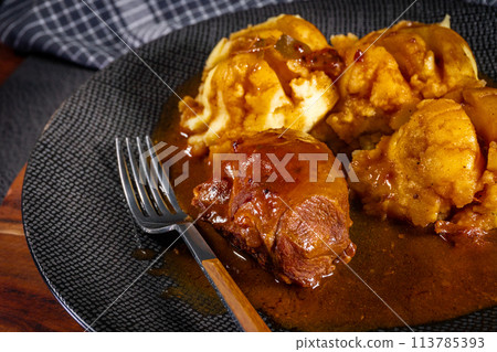 Traditional German braised pork cheeks in brown sauce. Traditional German braised pork cheeks in brown sauce. 113785393