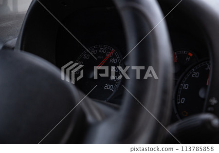 steering wheel and speedometer in the cockpit of a simple car steering wheel and speedometer in the cockpit of a simple car 113785858