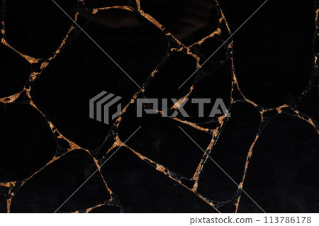Black Obsidian stone texture with gold leaf, semi precious background. 113786178