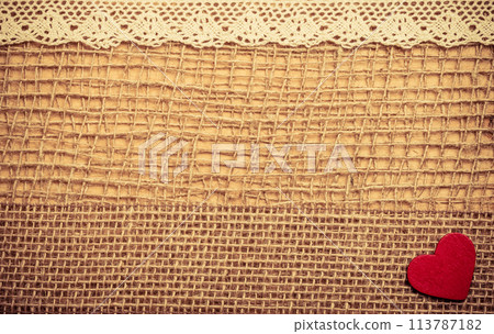 Red heart on abstract cloth background 113787182