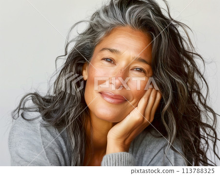 Smiling woman with grey wavy hair Smiling woman with grey wavy hair 113788325