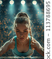 Focused female gymnast on balance beam, spotlighted by gym lights, demonstrates intense concentration 113788695