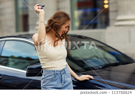 Happy woman driver hold keys car smiling. Cute young happy brunette female driving car vehicle 113788824
