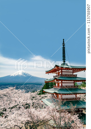 A red five-story pagoda and cherry blossoms in full bloom with a blue sky and Mt. Fuji in the background. A tourist image of Japan 113788907