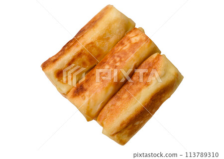 Delicious fried pancakes with filling rolled on a dark concrete background 113789310