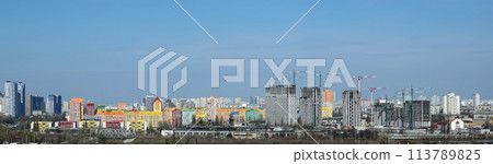 Kyiv, Ukraine April 7, 2022: tower construction cranes build high-rise buildings in Kyiv against the blue sky Kyiv, Ukraine April 7, 2022: tower construction cranes build high-rise buildings in Kyiv against the blue sky 113789825